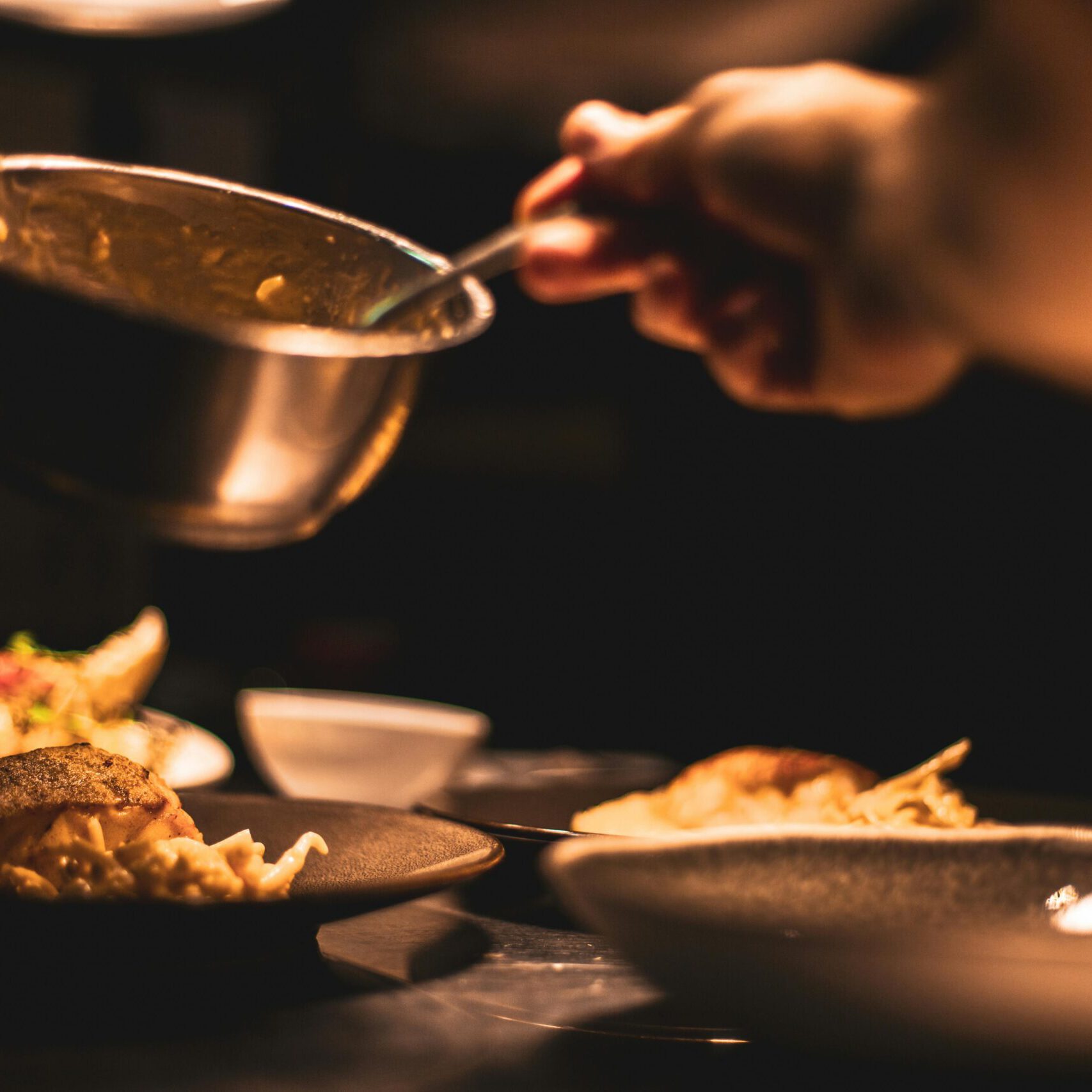 Person Holding Bowl To Plate Food